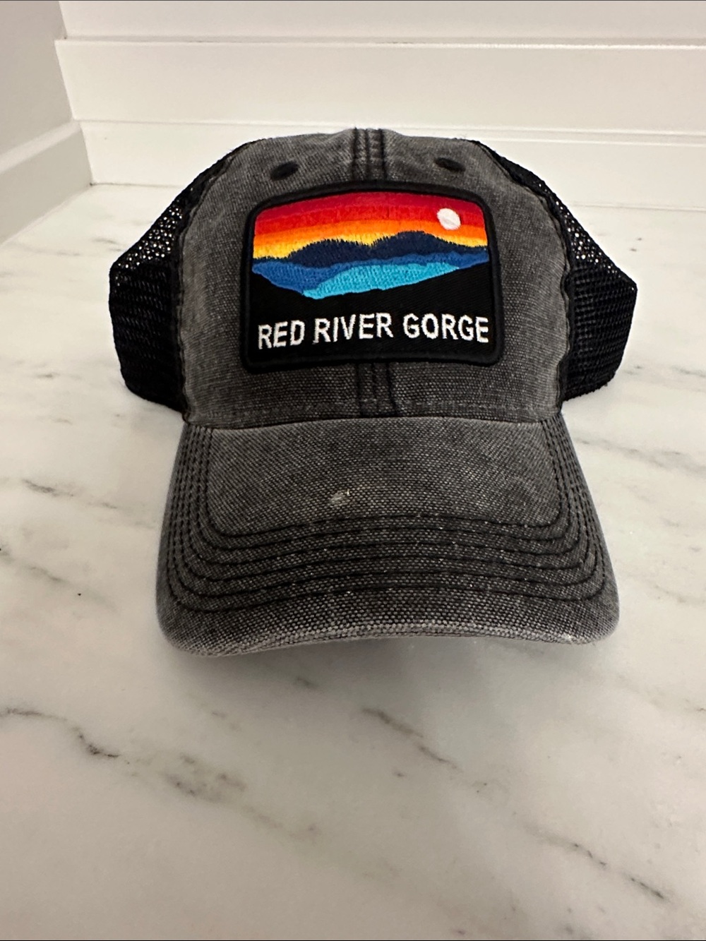 Black Mesh Trucker Hat. Logo red River Gorge. Like new